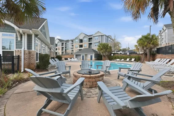 Fire pit surrounded by lounge chairs